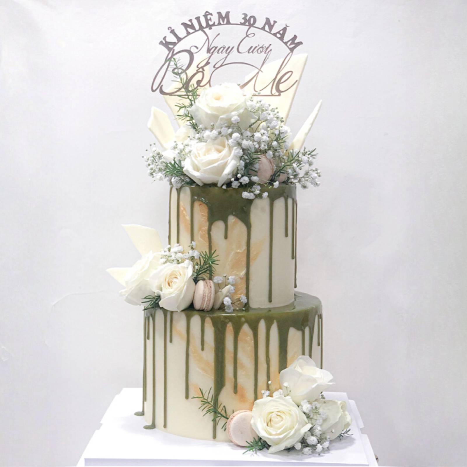 Hoa hồng trắng được điểm xuyết tinh tế trên bánh kỷ niệm ngày cưới, tượng trưng cho tình yêu thiêng liêng